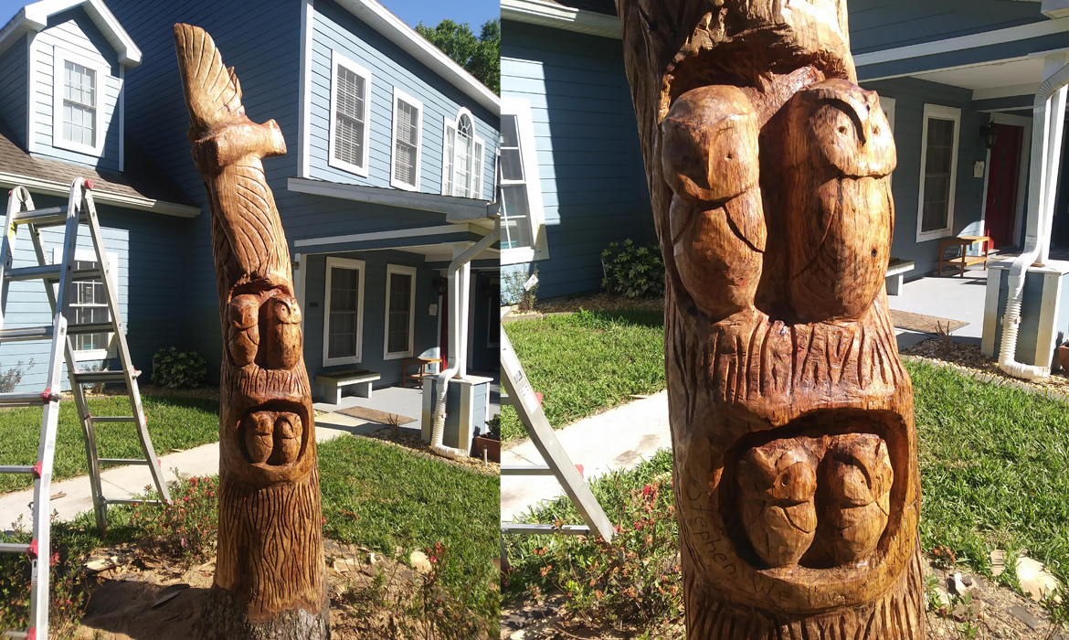 Memorial, tree trunk carving of a family of owls